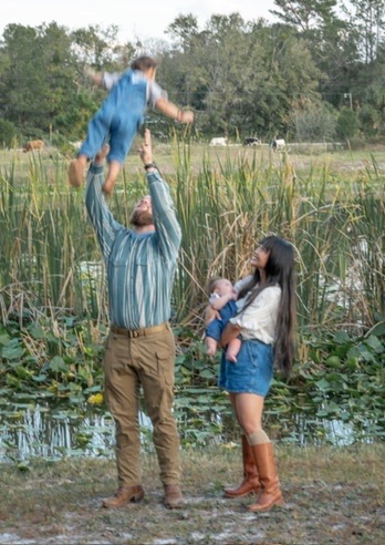 Jacob and Rizza White with their children beside a Florida pond