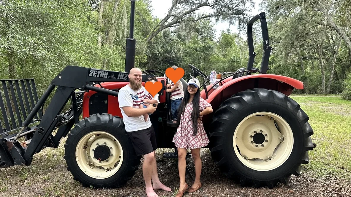 The White family together beside a tractor in rural Florida